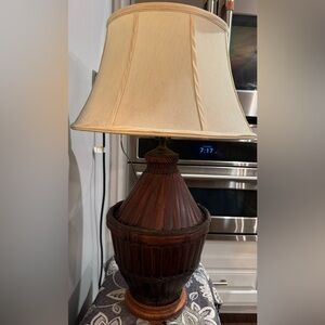 Vintage or mid-century style table lamp w/wicker base and a fabric shade.
